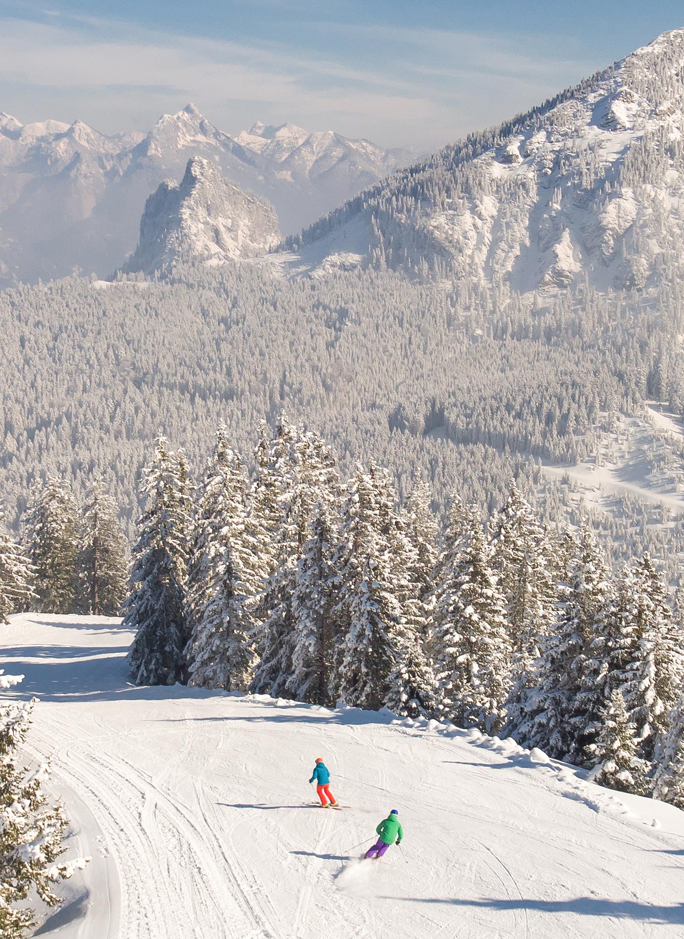 Winter sports scene at Breitenberg - Hochalpe - Pfronten in Bavaria, with a skier descending the snowy slopes. A quaint challet and stunning winter scenery adorns the background.