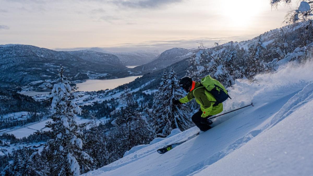 Sogn Skisenter in Norway - a person skiing down a snowy slope in the mountains.