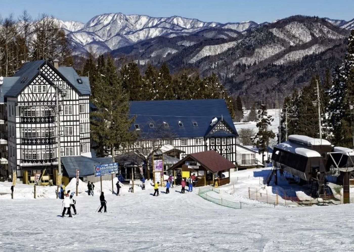 Sun Valley Resort in Japan - a group of people are skiing on the snow.