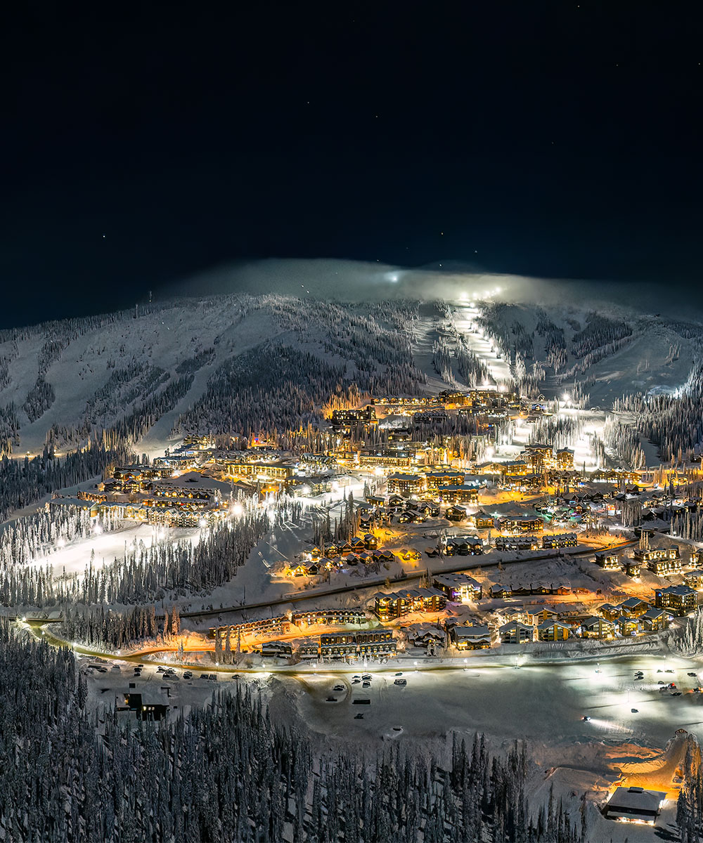 White Hills in Canada - a city lit up at night in the mountains.