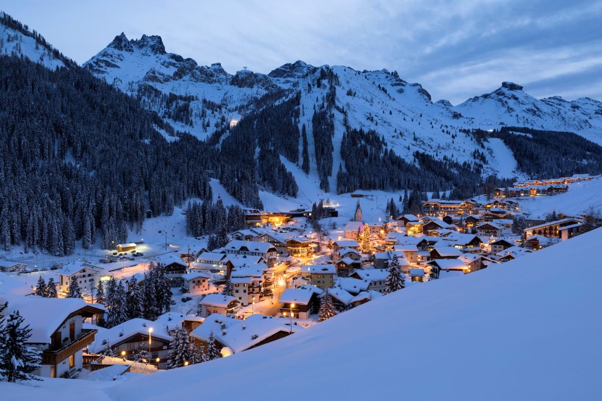 Arabba Marmolada in Italy - a snowy town in the mountains at night.