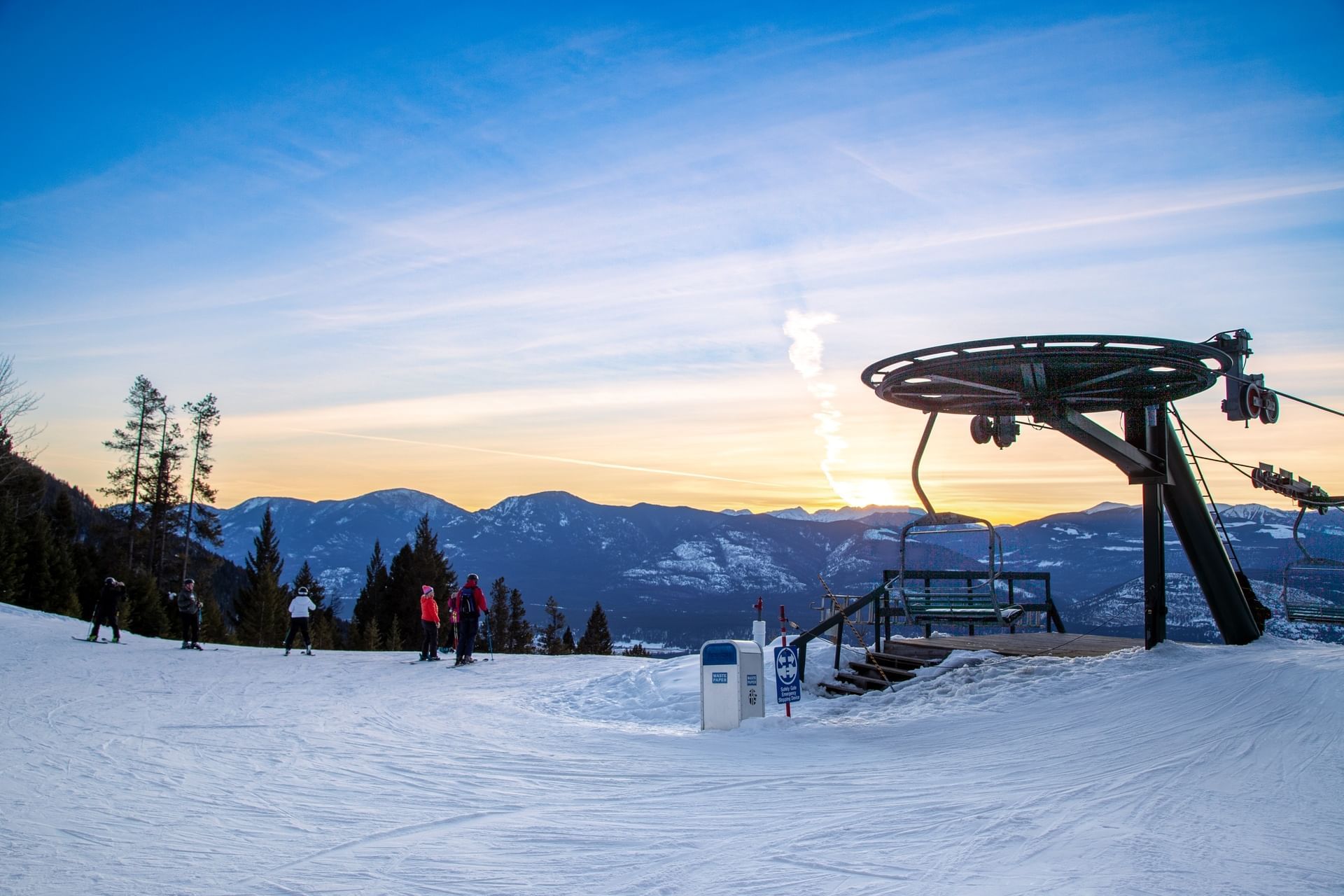 View of the picturesque Fairmont Hot Springs in the Kootenay Rockies, British Columbia, Canada, featuring a ski lift and resort set against a stunning winter backdrop.