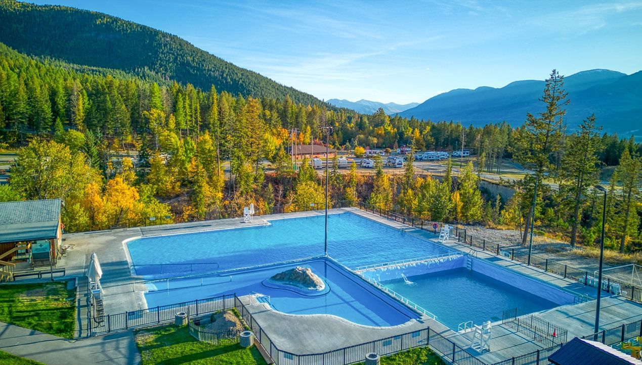 Fairmont Hot Springs in Canada - a large swimming pool surrounded by trees and mountains.