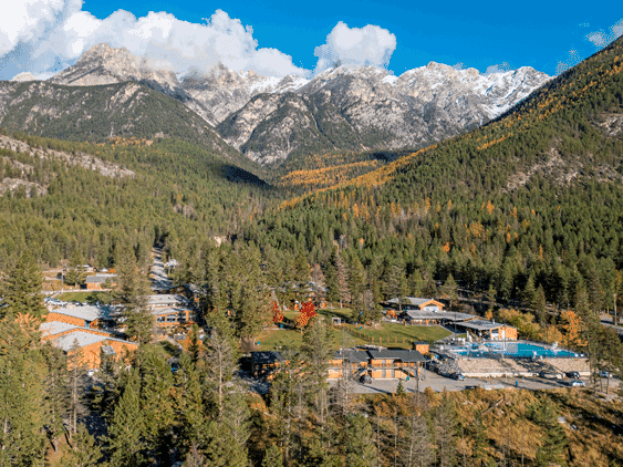 A charming scene at Fairmont Hot Springs' ski resort in British Columbia Canada featuring a challet amidst the snow-covered mountainous terrain depicting the beauty of winter.