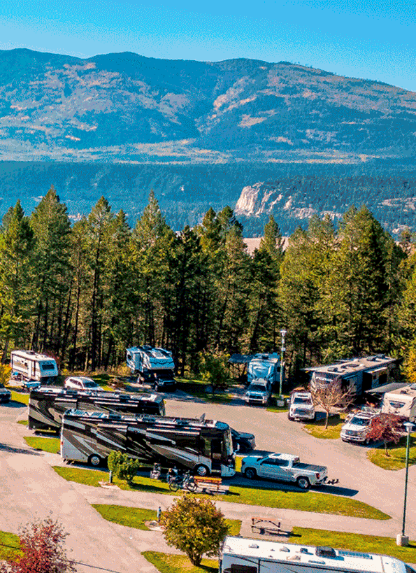 Spectacular view of Fairmont Hot Springs Ski Resort in Kootenay Rockies, featuring a lodge, challet, and mountain amidst a vibrant winter sports scene in British Columbia, Canada.