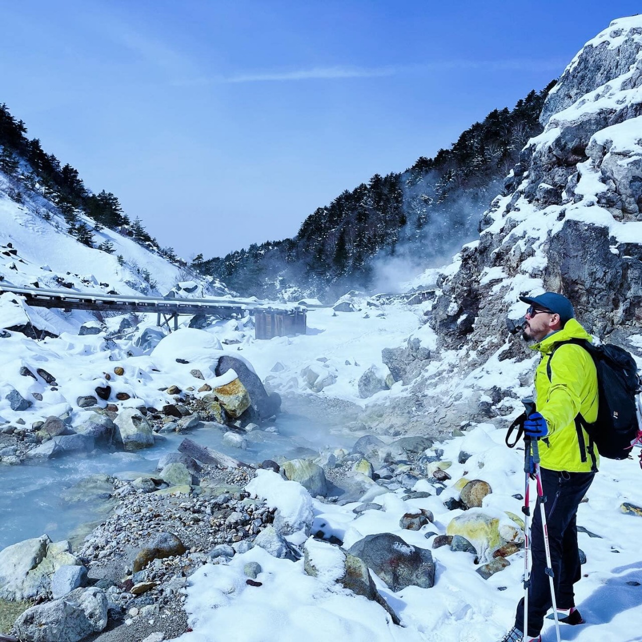 Numajiri in Japan - a man in a yellow jacket standing in the snow.