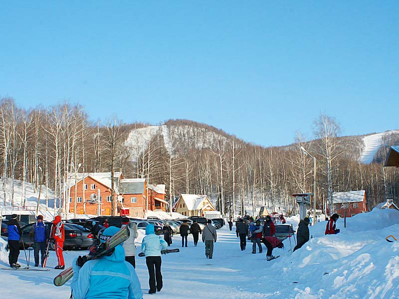 Winter sports enthusiasts enjoying activities at Adzhigardak ski resort in Asha, Ural Federal District, Russia, amidst an enchanting winter scenery.