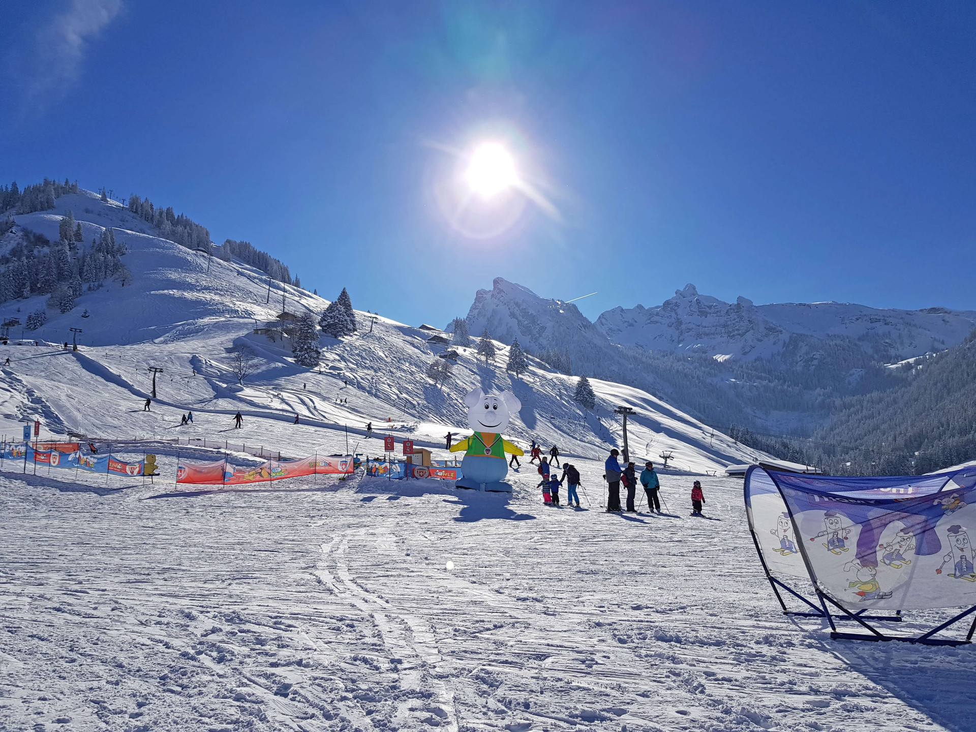 A skier enjoying a winter sports scene at Grimmialp in Bernese Oberland Switzerland. The frosty landscape hosts a winter sports centre ski resort and charming chalet.