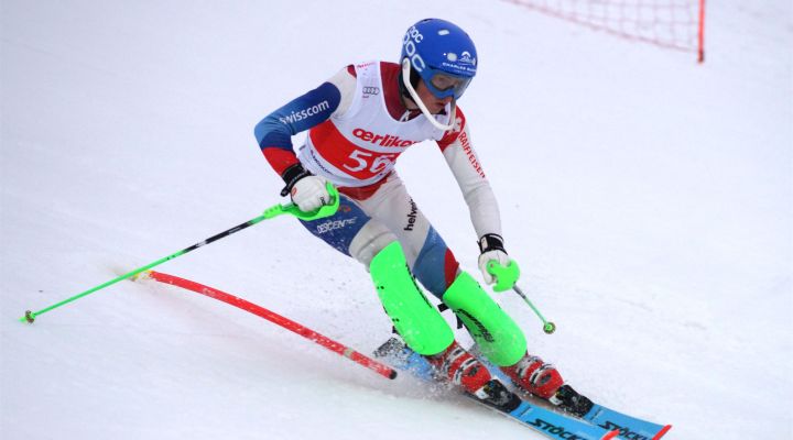 A skier navigating the snowy slopes near a charming chalet at Ebenalp-Horn in Appenzellerland, Schwende, Eastern Switzerland, illustrating a lively winter sports scene.