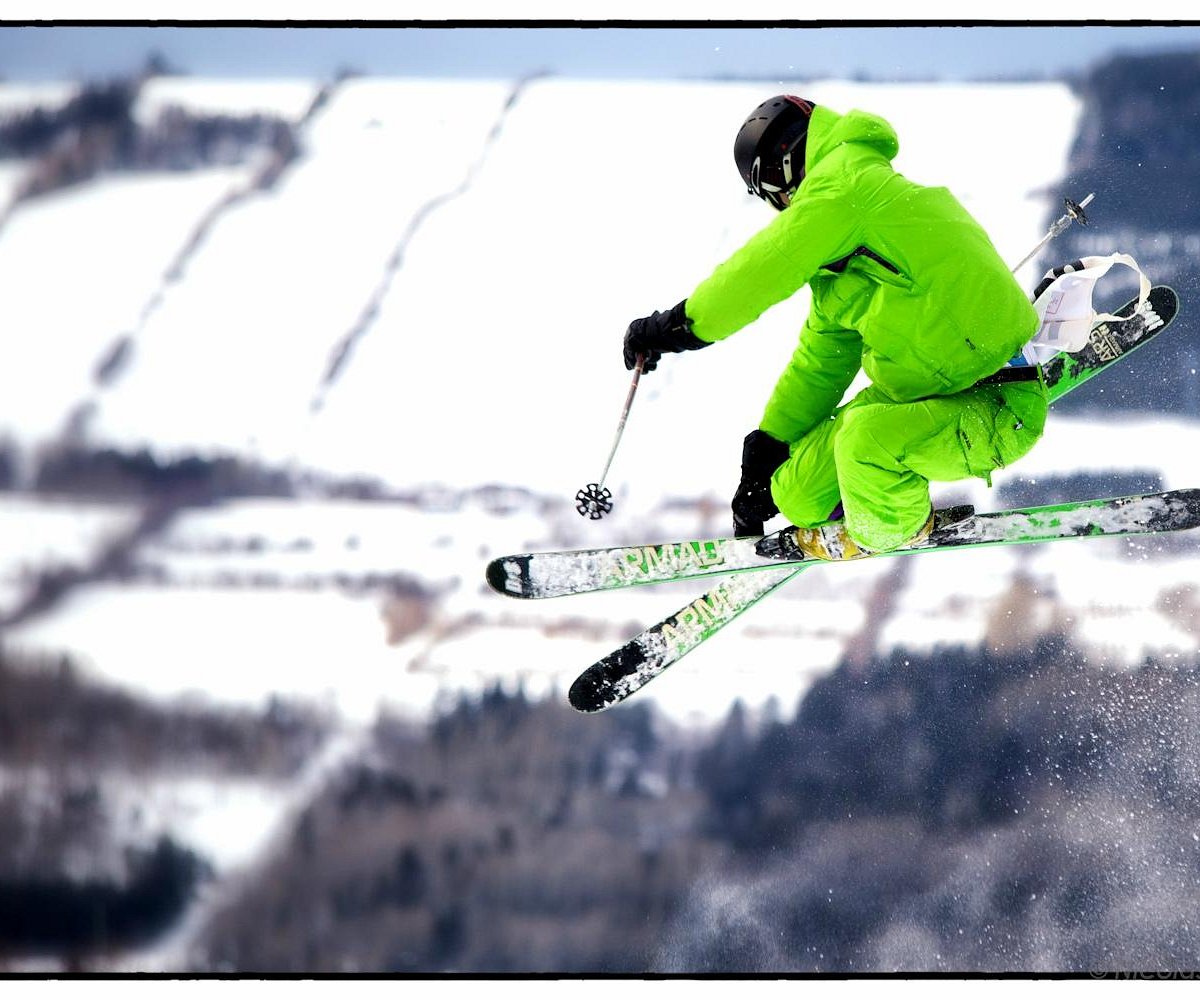 Mont-Saint-Mathieu in Canada - a person jumping in the air on skis.