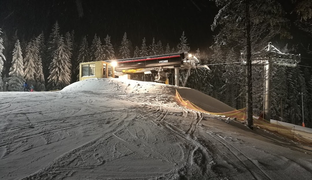 View of the ski resort in Kopřivná Malá Morávka Czech Republic featuring a winter sports scene with a ski lift and skiers.