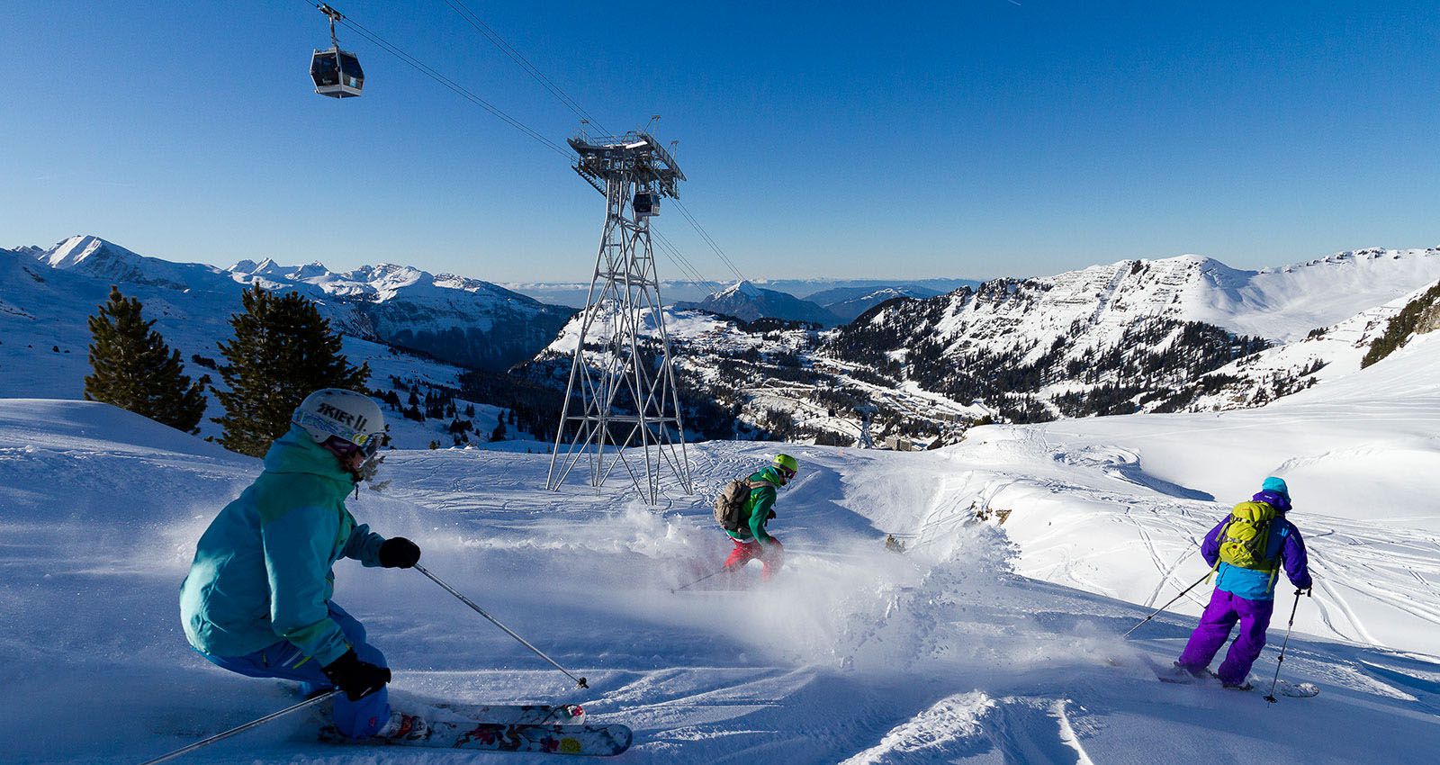 Le Grand Massif in France - a group of people skiing down a mountain.