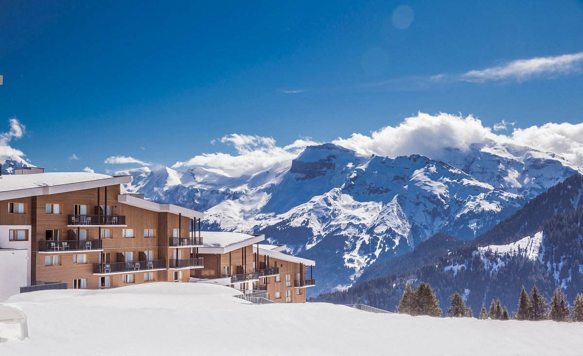 Le Grand Massif in France - a house in the snow with mountains in the background.