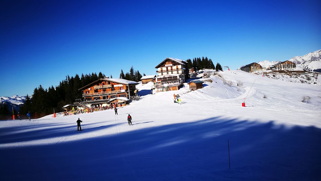 Le Grand Massif in France - a group of people skiing down a snow covered slope.