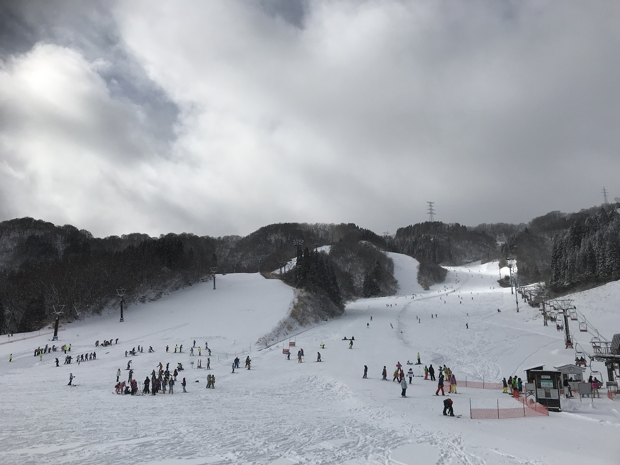Imajo 365 in Japan - a group of people skiing down a snow covered slope.