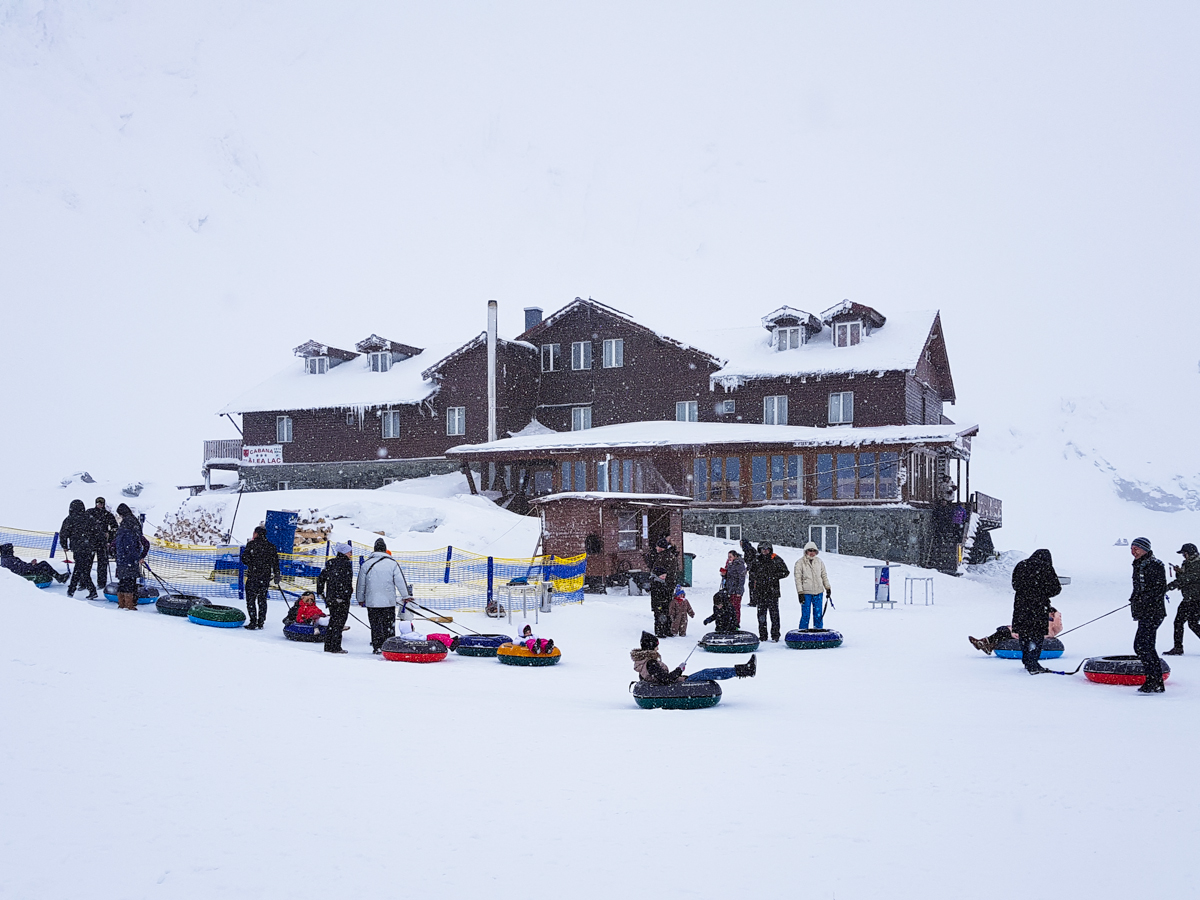 Balea Lac resort in Romania - a group of people standing outside in the snow.