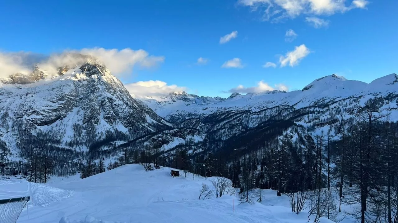 A picturesque winter scene at Alpe Devero ski resort in Piedmont Italy. The image captures a breathtaking view of snowy mountains under a clear sky highlighting the sheer beauty and magnificence of winter sports locations.