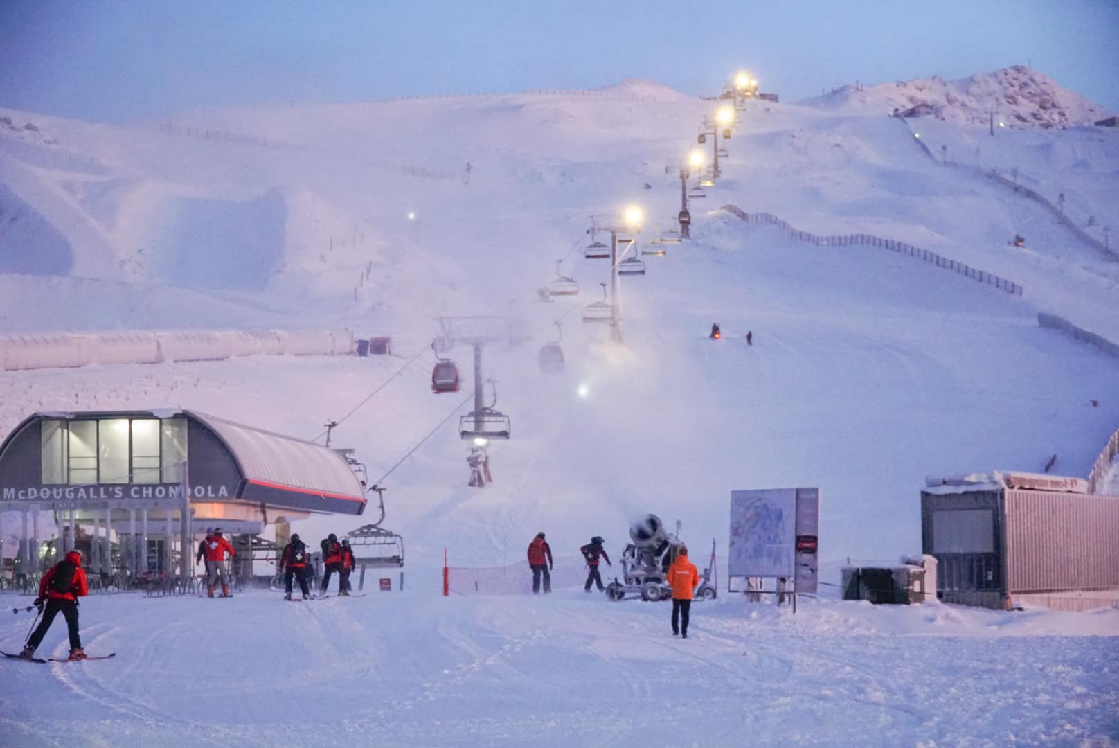 Mt Lyford in New Zealand - a group of people skiing down a snow covered mountain.