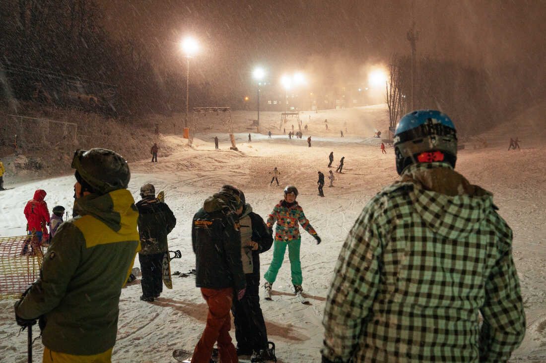 Play in Ukraine - a group of people standing in the snow.