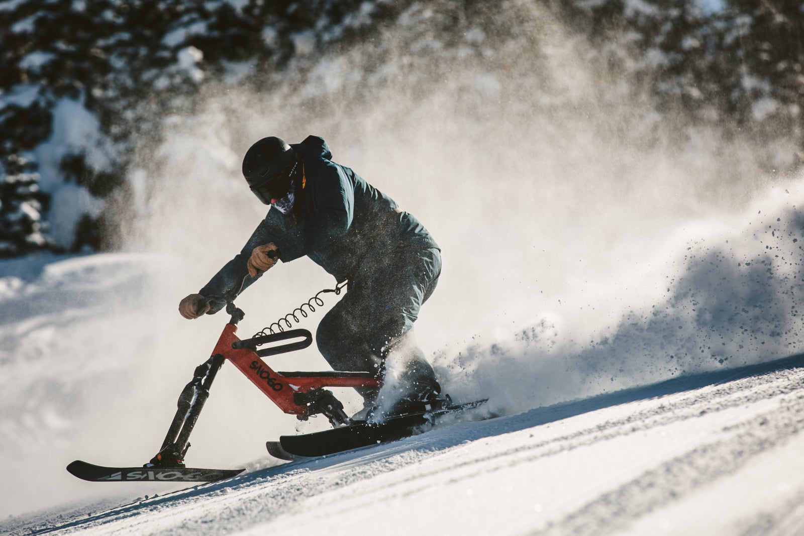 Play in Ukraine - a man riding a snowboard down a snowy slope.