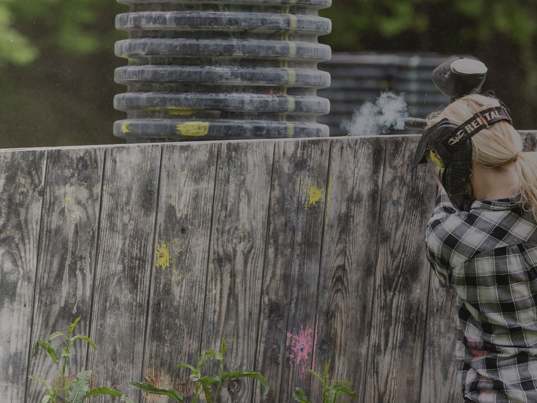 Roundtop in USA - a woman in a plaid shirt shooting a gun.