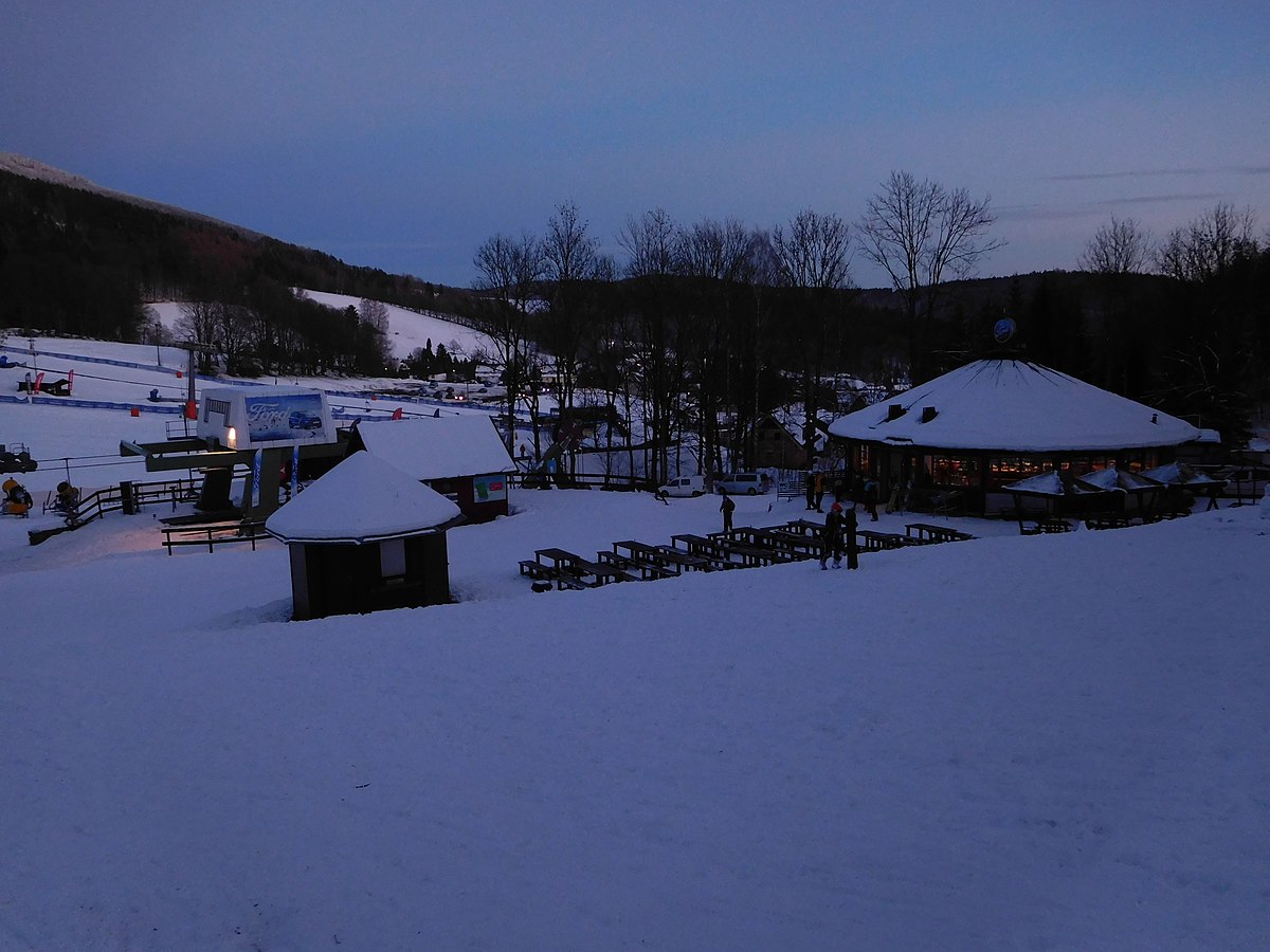 Černý Důl in Czech Republic - a snow covered ski area with tables and chairs.