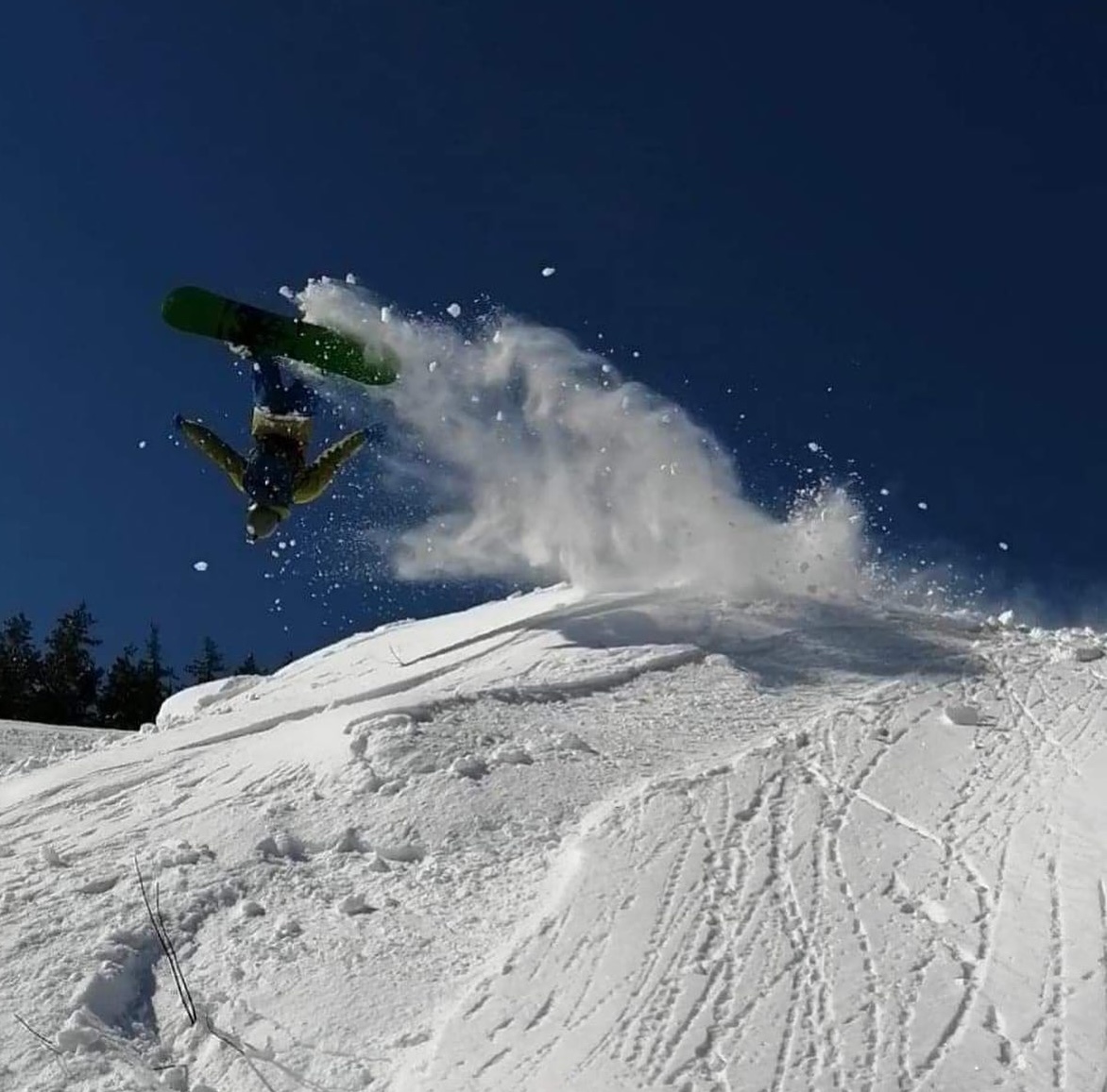 Mount Jamieson in Canada - a snowboarder is doing a trick in the air.