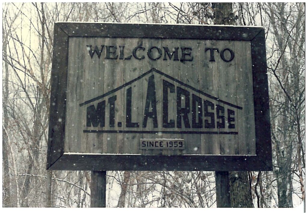 Winter scene at Mt. La Crosse, Wisconsin, featuring a cozy lodge and charming chalet amongst a bustling ski resort and sports centre.