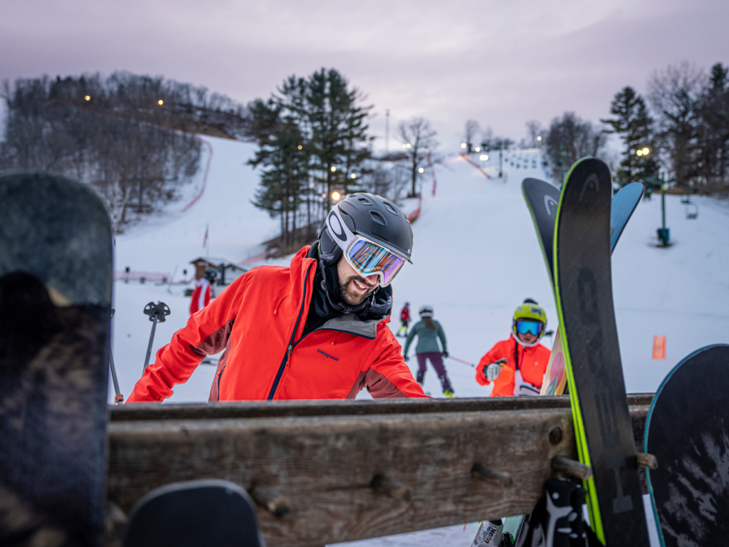 Mt. La Crosse in USA - a man in a red jacket holding a snowboard.