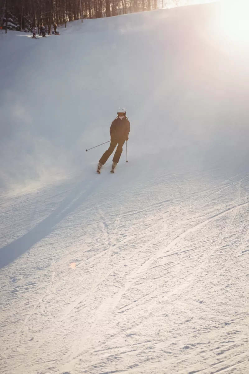 Świeradów Zdrój SKI & SUN in Poland - a person skiing down a hill on a sunny day.