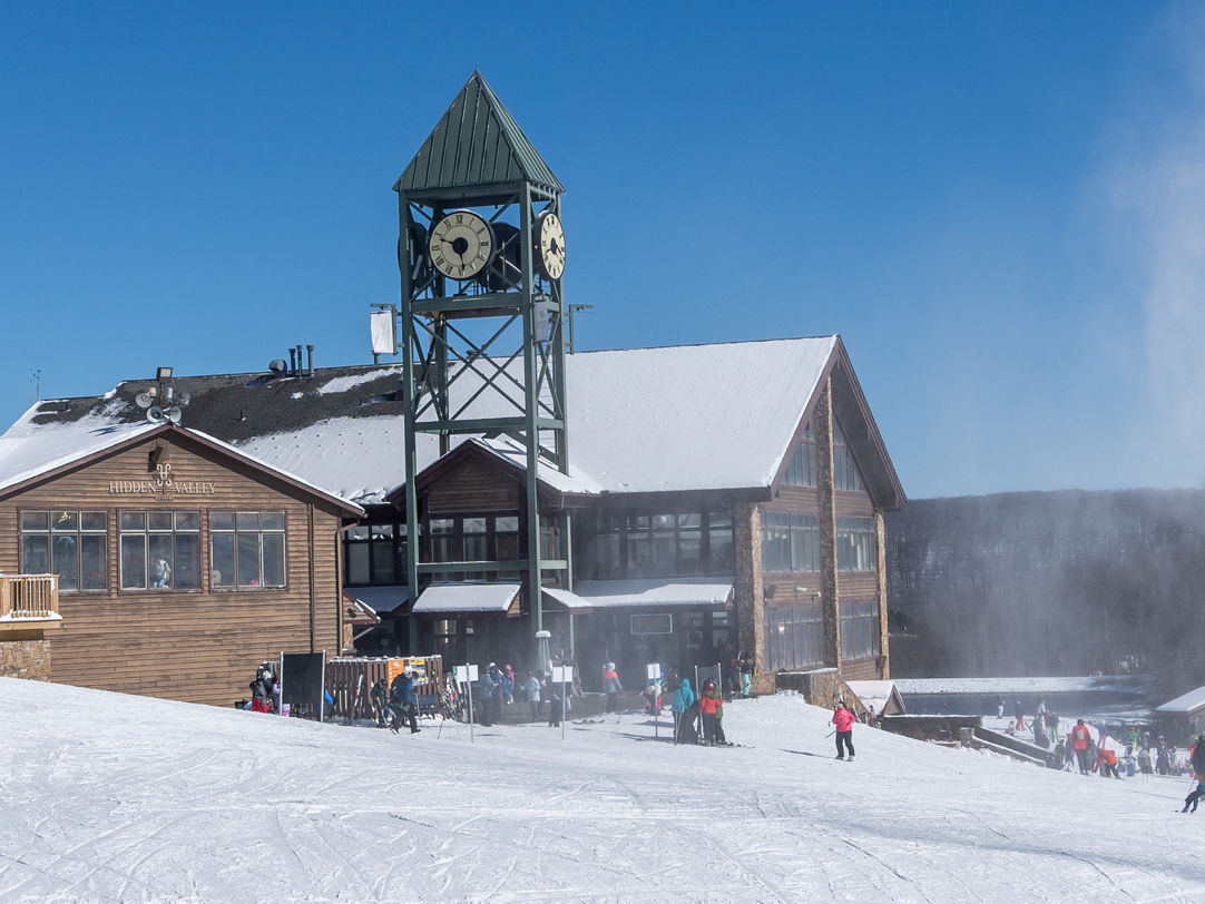 Hidden Valley in Canada: a group of people standing in the snow near a building.
