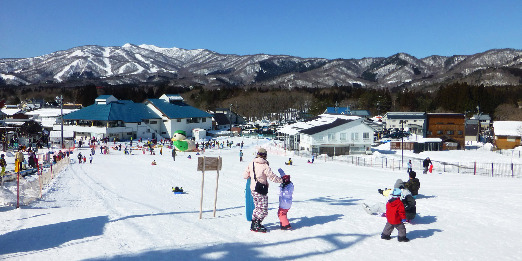 Hirugano Kogen in Japan - a group of people skiing down a snowy hill.
