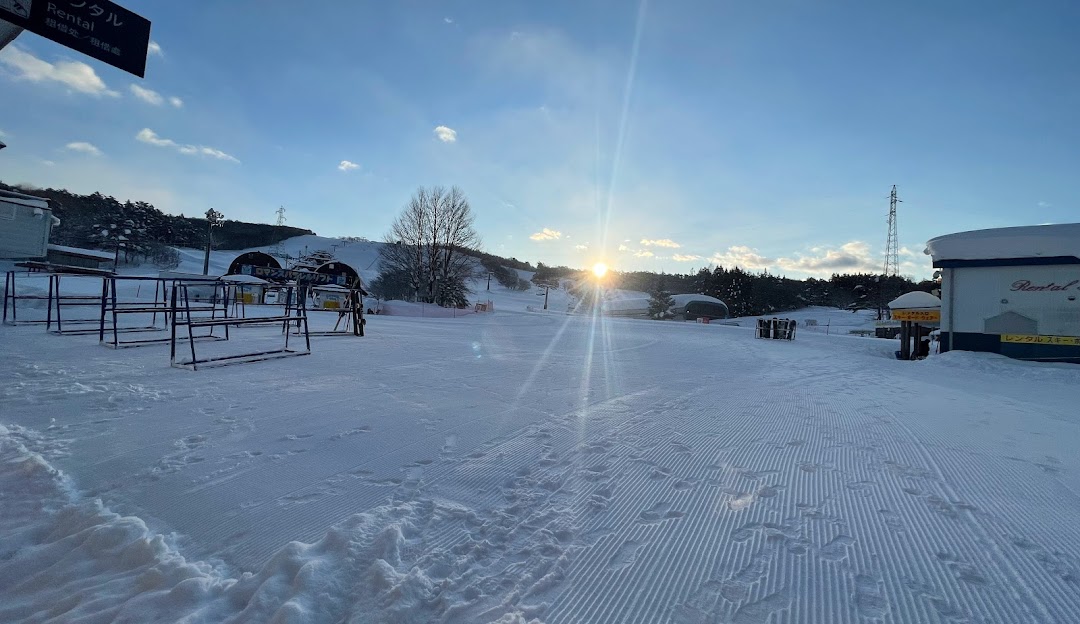 Winter sports scene at Hirugano Kogen in Japan, featuring a bustling winter sports centre amidst stunning snow-covered scenery at a ski resort.