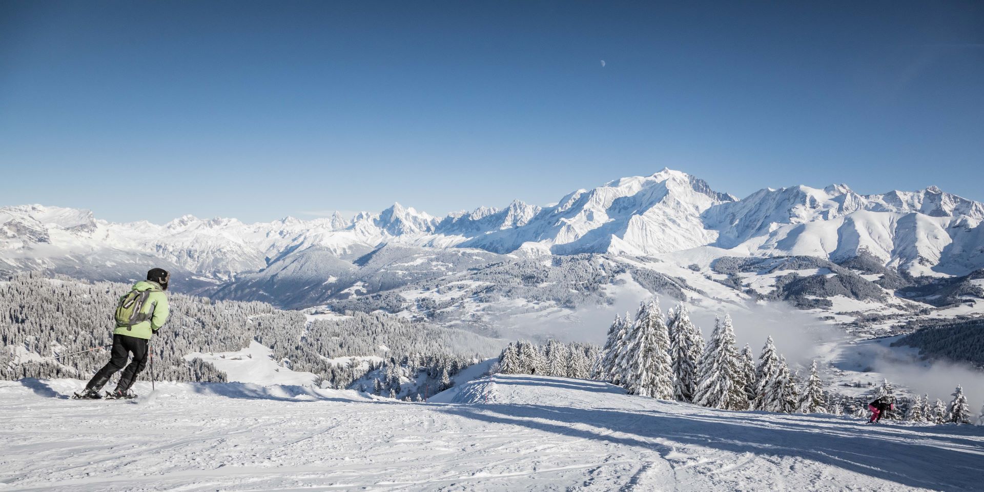 Megève in France - a person standing on top of a snow covered mountain.