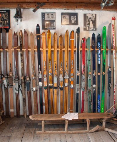 Winter sports scene at Megève ski resort in France, featuring a chalet and a skier enjoying the snowy slopes.