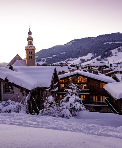 Winter scene at Megève ski resort in France, featuring a chalet nestled amid the snow-covered landscape, a hub of winter sports activities.