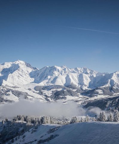 Charming chalet nestled in snowy Megève, a ski resort in Auvergne-Rhône-Alpes, France. Spectacular mountain backdrop completes this stunning winter scenery.