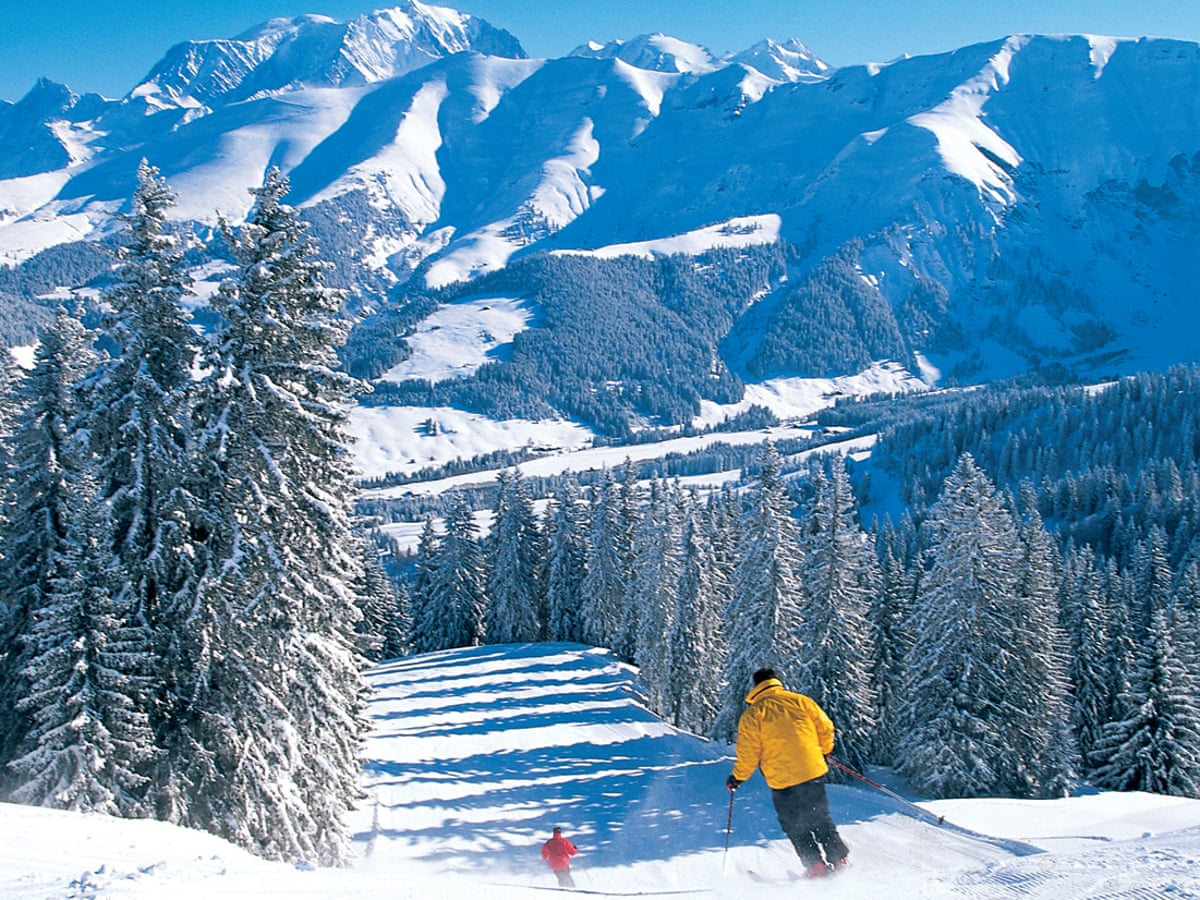 Megève in France - a person skiing down a snowy mountain.