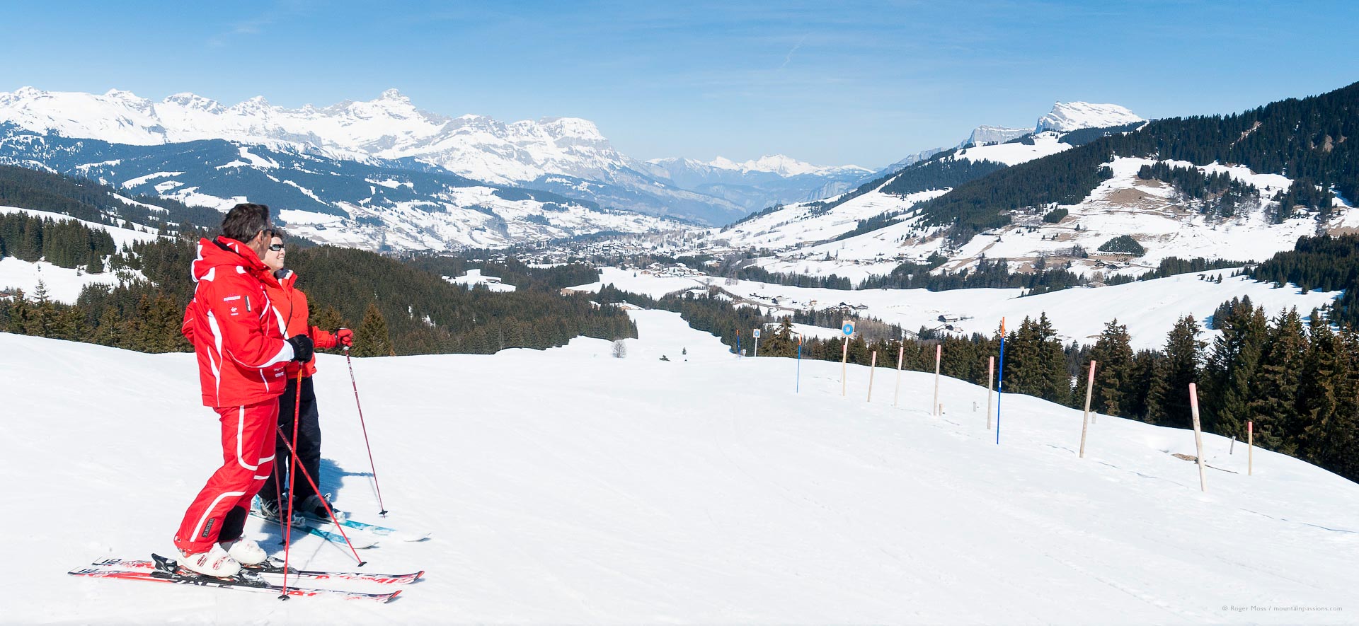 Megève in France - a man in a red jacket is standing on skis.