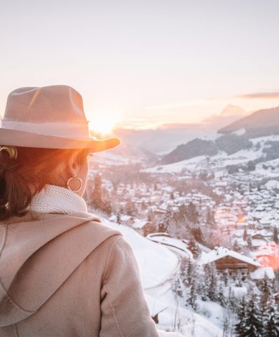Winter scenery in Megève, France, showcasing a stunning snowy landscape bustling with winter sports activity, a chalet nestled amidst the snow, and a radiant sun illuminating the vibrant ski-town.