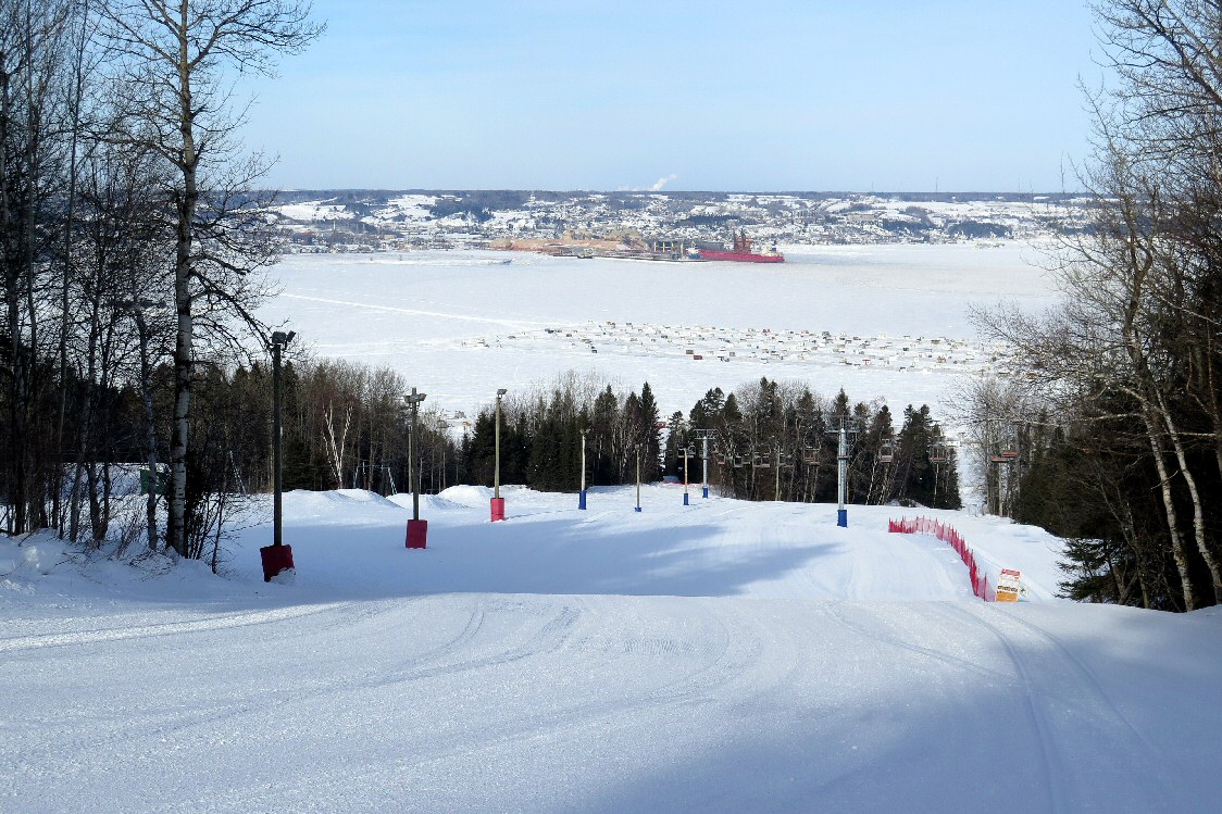 Mont-Bélu in Canada - a ski slope with trees and snow on the ground.