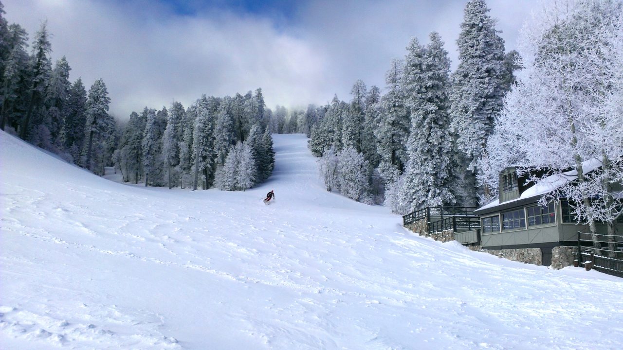 Mt Lemmon Ski Valley in USA - a person is skiing down a snowy hill.