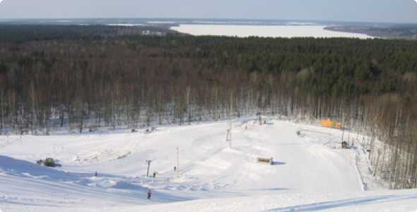 Winter scene at Norway Mountain in Michigan, USA. Enthusiasts enjoying a day at the winter sports center, featuring a ski resort and a cozy chalet amidst the picturesque white landscape.