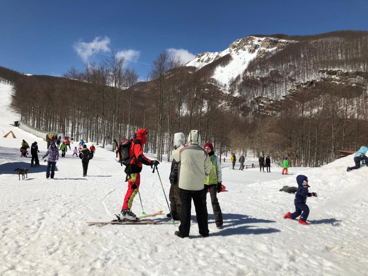 Prato Spilla in Italy - a group of people skiing down a snow covered slope.