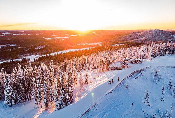 A picturesque winter scene at Säfsen ski resort in Fredriksberg Central Sweden. Various winter sports activities can be observed on the snow-covered slopes with a ski lift visible in the background.