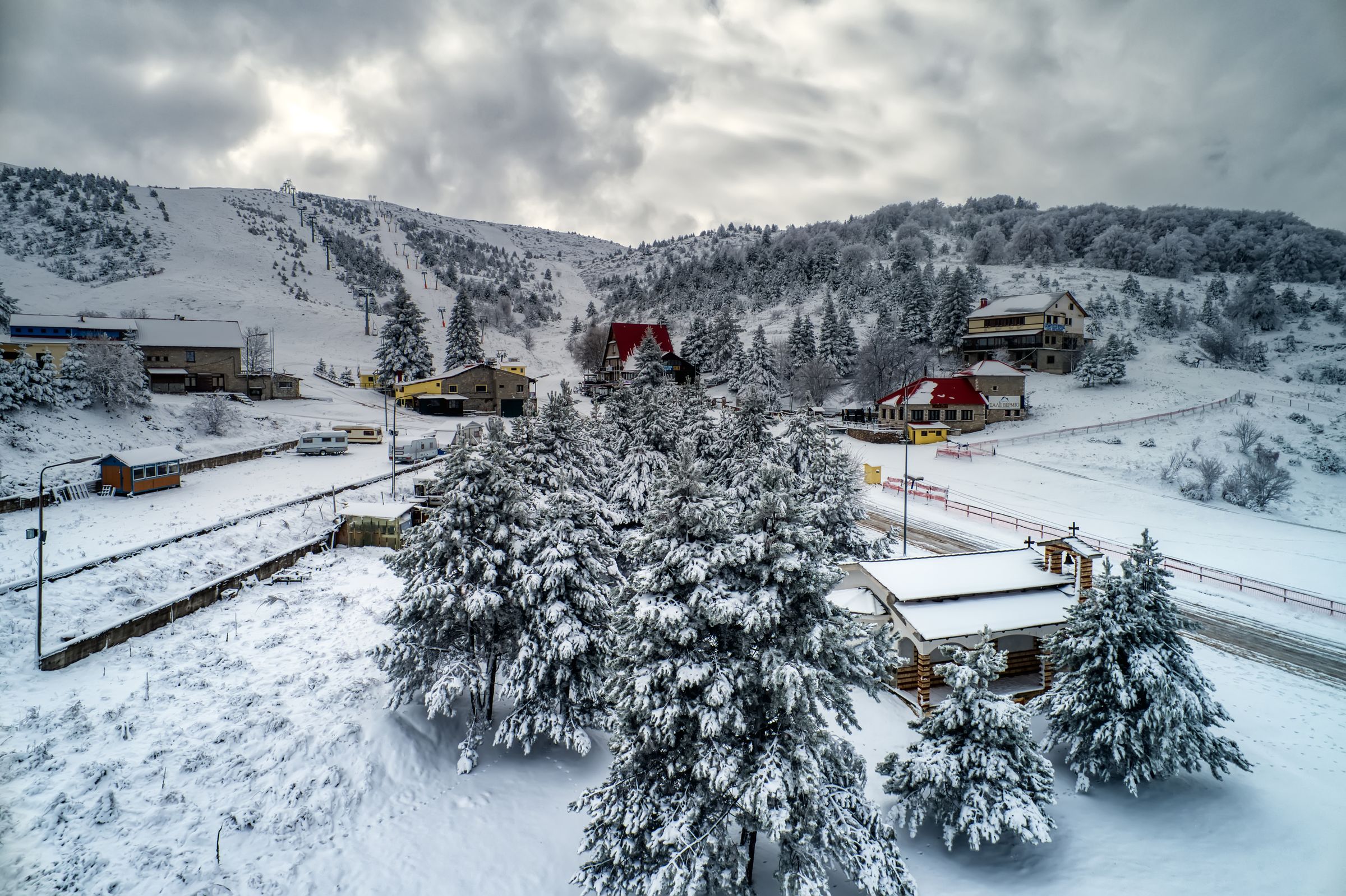Picturesque winter scene at Seli ski resort in Kato Vermio Greece showcasing a bustling winter sports scene amidst stunning snow-covered landscapes.