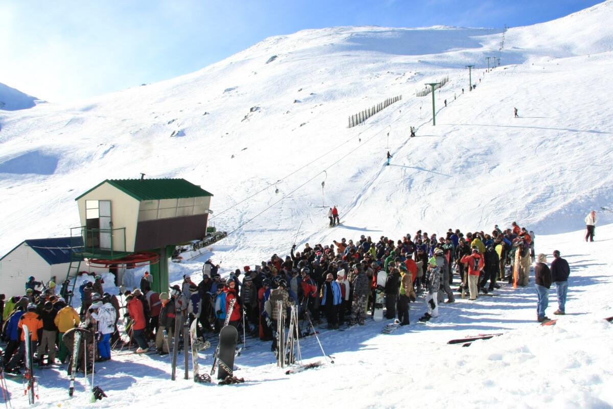 Mt Dobson in New Zealand - a group of people standing in the snow.
