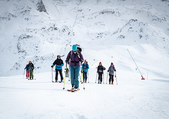 Group of skiers possibly a family enjoying winter sports at Les Arcs | Peisey-Vallandry ski resort in Savoie Mont Blanc Auvergne-Rhône-Alpes France.