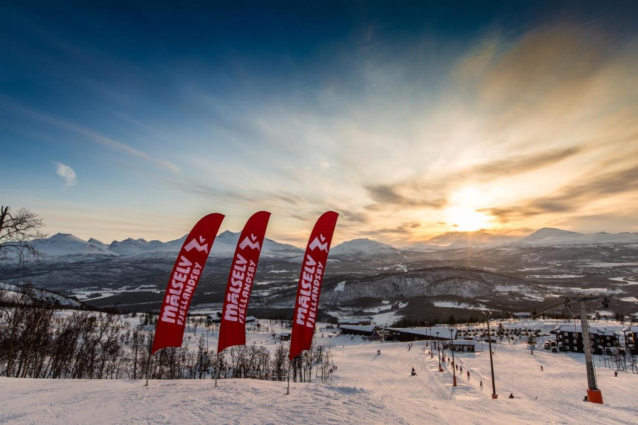 Målselv Fjellandsby in Norway - the sun is setting over the mountains and ski slopes.