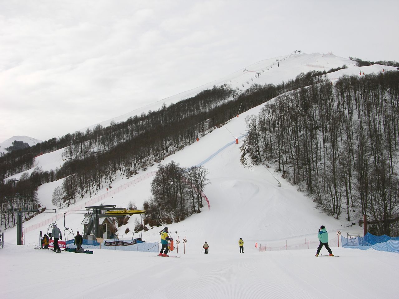 Winter sports scene at Scanno-Monte Rotondo in Abruzzo, Italy featuring a ski resort, ski lift, and skier.